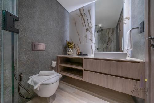 a bathroom with a toilet and a sink at Grove Luxurious Stu Best community Art & Design in Dubai