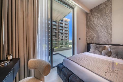 a bedroom with a bed and a large window at Grove Luxurious Stu Best community Art & Design in Dubai