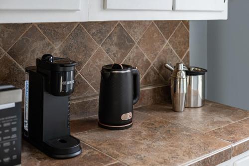 a coffee maker on a counter in a kitchen at Cozy Home, 19 min to NYC, 3 Car Driveway in Wallington