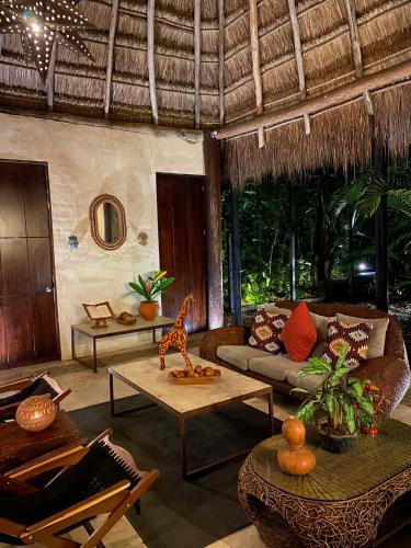 a living room with a couch and a table at Piedra de Agua Palenque in Palenque