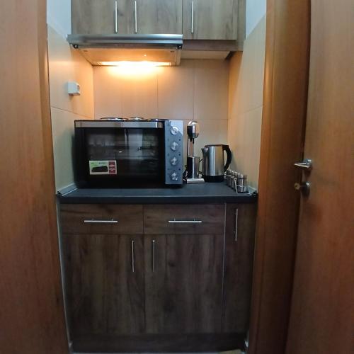 a microwave sitting on top of a counter in a kitchen at Nancy view apartment in Markopoulo