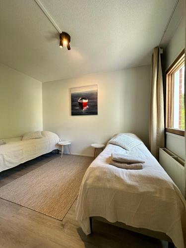 a bedroom with two beds and a window at Modern studio, good location, free parking in Kuopio