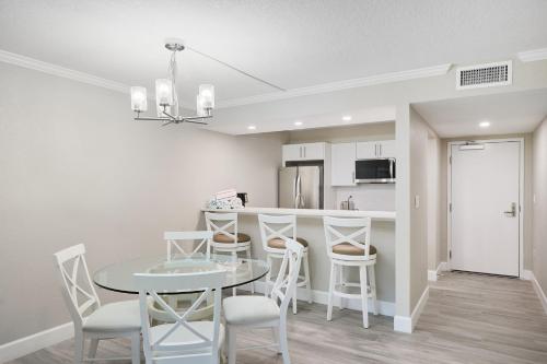 a kitchen and dining room with a table and chairs at Sundial F106 - Renovated Ground Floor Residence at Sundial Sanibel in Sanibel