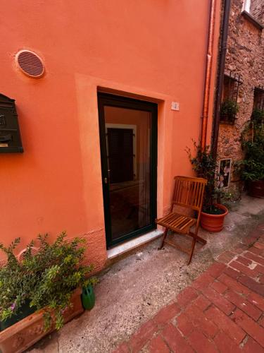 a wooden bench sitting in front of a building at Bia Apartments pt in Monte Marcello