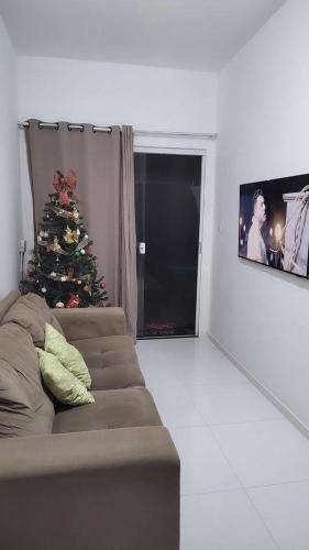 a living room with a christmas tree and a couch at Beach House in Camaçari
