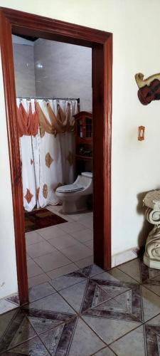 a bathroom with a toilet and a shower curtain at Relax Quinta carlis 