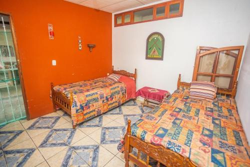 two beds in a room with orange walls at Relax Quinta carlis 
