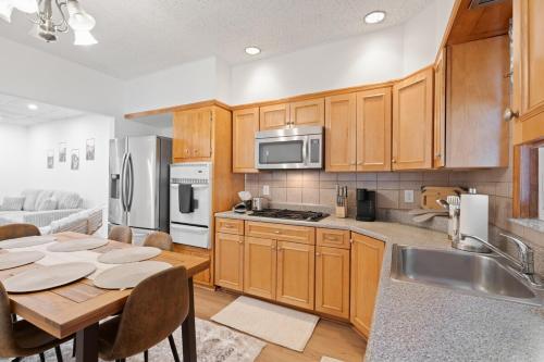 a kitchen with wooden cabinets and a wooden table with a dining room at Cozy Lodi Home ,23m to NYC, 3Car Driveway in Lodi