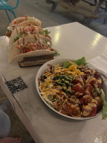 a table with two sandwiches and a plate of food at Arecibo's country cottage in Arecibo