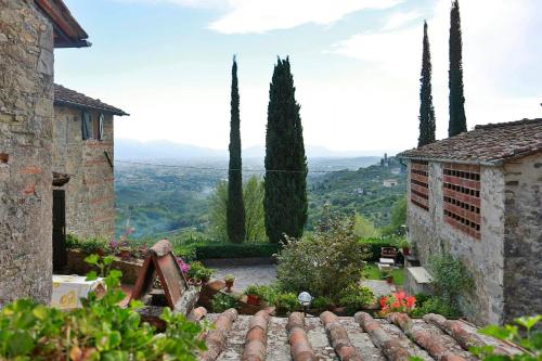 a view from the garden of a house with trees at Villa With Views Over Lucca Hills in Matraia