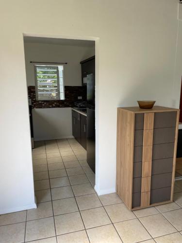 a kitchen with a table and a counter in a room at Arecibo's country cottage in Arecibo