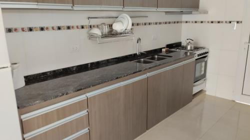 a kitchen with a sink and a stove at LOS NARANJOS in Reconquista