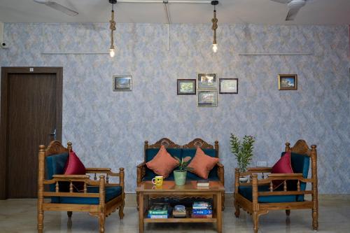 a living room with two chairs and a table at City Central Hostel in Kolkata
