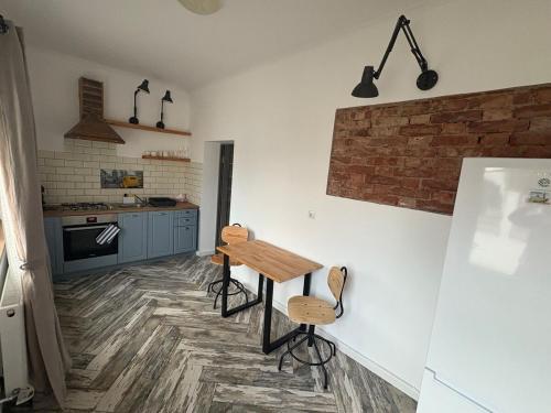 a kitchen with a wooden table and chairs in it at Airport Green 2 in Cluj-Napoca