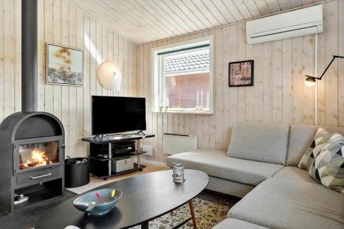 a living room with a couch and a fireplace at 8237-Vordingborg-Vildgasvej-7 in Vordingborg
