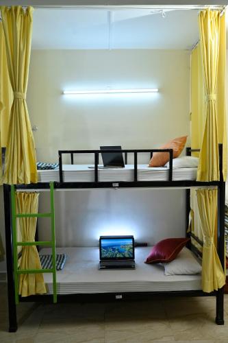 a laptop computer sitting on top of a bunk bed at City Central Hostel in Kolkata
