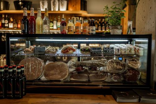 a display case filled with lots of different types of food at MT Suites ApartHotel in Budapest
