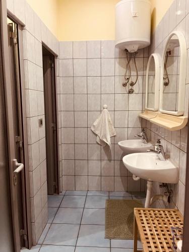 a bathroom with two sinks and a mirror at Apartman Vinkov's center in Jajce