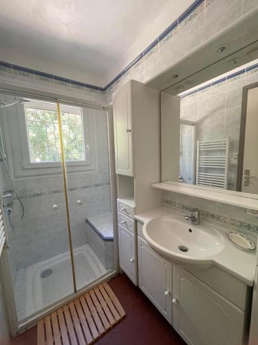 a bathroom with a sink and a shower at Villa Les Chênes - Golfe de Saint-Tropez Experience in Port Grimaud