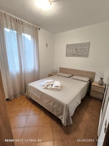 a bedroom with a bed with towels on it at Dimora Nella Roccia in San Siro
