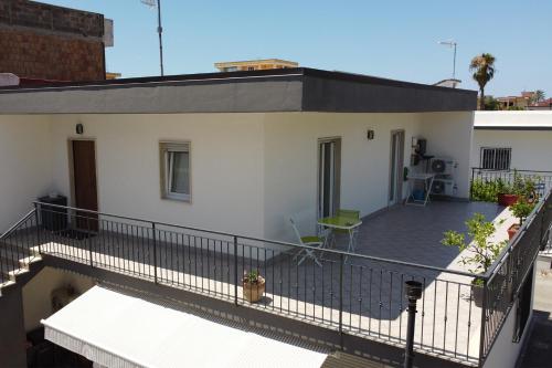 a house with a large balcony with a deck at A Casa di Falco in Mondragone