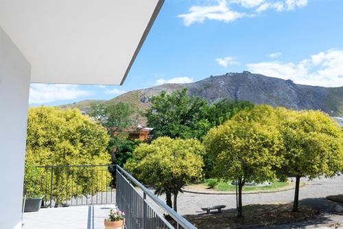 a balcony with trees and a mountain in the background at A Casa di Falco in Mondragone