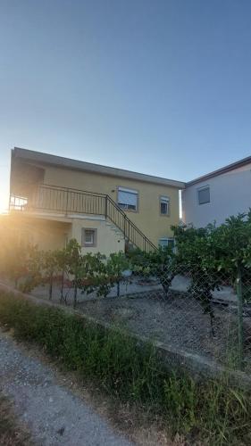 a building with a staircase and trees in front of it at Apartmani Ksenija in Bar