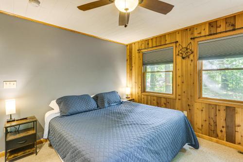 a bedroom with a blue bed and a ceiling fan at 11 Mi to Gettysburg Serene Home in Fairfield in Fairfield