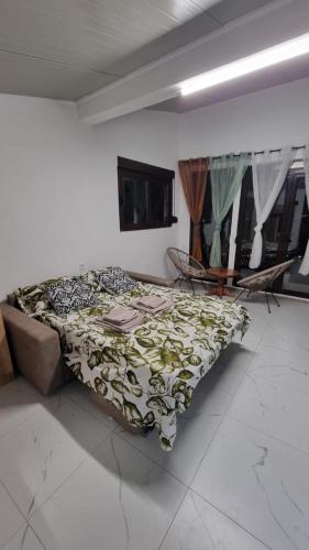 a bedroom with a bed in a room with windows at Kotor Bay View Apartments in Bijela