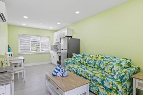 a living room with a couch and a refrigerator at The Hideaway Cottage at Palmview Inn of Sanibel in Sanibel