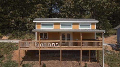 a house with a wrap around porch with a deck at The Honeycomb House in Chattanooga
