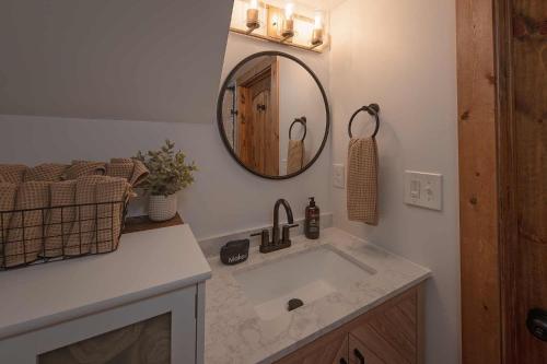 a bathroom with a sink and a mirror at The Honeycomb House in Chattanooga