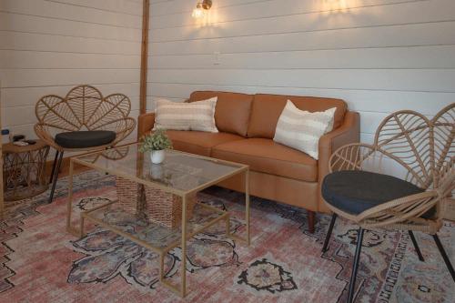 a living room with a couch and a table and chairs at The Honeycomb House in Chattanooga