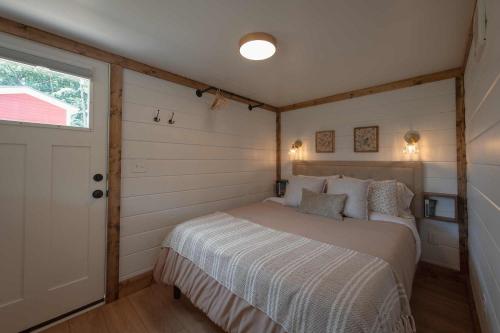 a bedroom with a bed in a room with a window at The Honeycomb House in Chattanooga