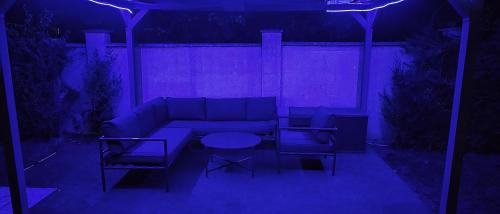 a living room with a couch and two chairs and a table at Къща за гости ,,Ива'' in Bŭlgarevo