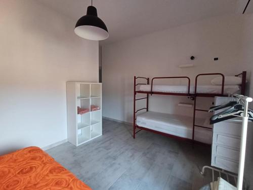 a bedroom with two bunk beds and a lamp at Dimora mediterranea Fontanamare in Gonnesa