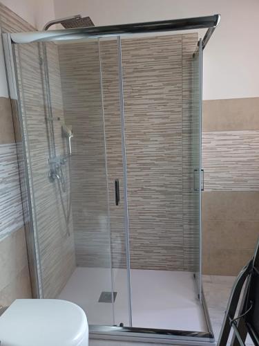 a shower stall in a bathroom with a toilet at Dimora mediterranea Fontanamare in Gonnesa