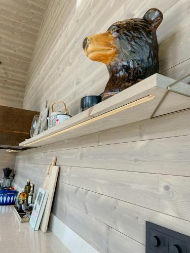 a statue of a bear head sitting on top of a shelf at Stylish Cabin In Scenic Surroundings in Skare