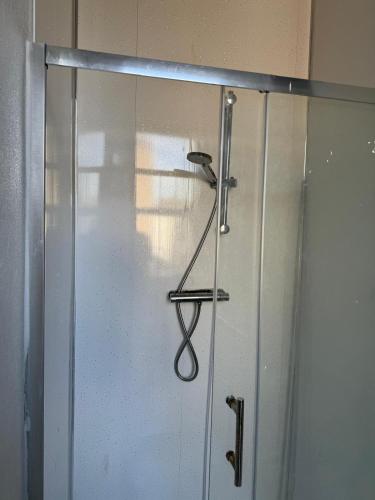 a sliding glass door with a hanger on it at Almar Hotel Apartments Blackpool in Blackpool