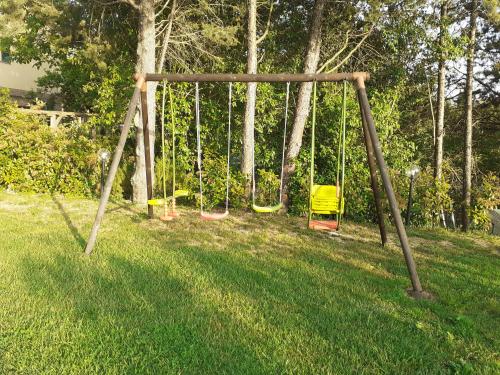 an empty swing set in a field of grass at Il Lavandeto - farmhouse in the city in Siena