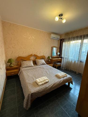 a bedroom with a bed with two towels on it at Pomorie S&T Home in Pomorie