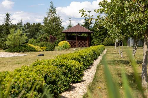 a gazebo in the middle of a garden at Jak u Dziadka 