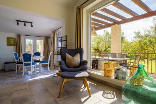 a living room with a chair and a large window at Ferienhaus Rovinj mit Pool in Rovinj