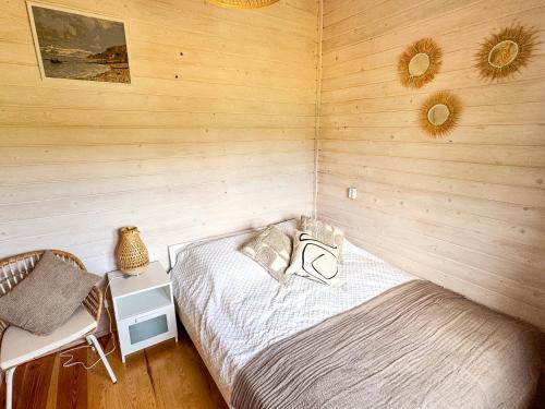 a bedroom with a bed in a wooden wall at Jak u Dziadka 