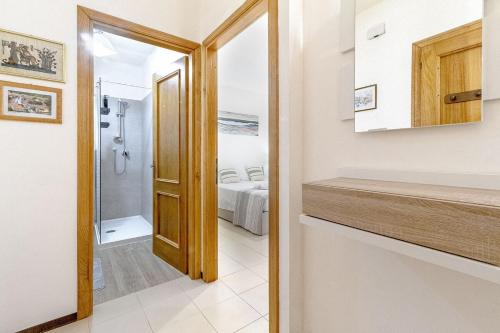 a bathroom with a walk in shower and a sink at Nura's - Luna Charme House in Alghero