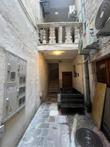 an empty hallway with a staircase in a building at Tetka Guest House in Kotor