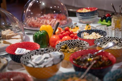 a table with many bowls of food on it at Landgasthof "Wilder Mann" in Innsbruck