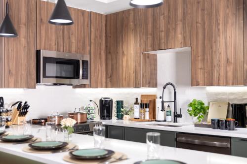 a kitchen with wooden cabinets and a white counter top at Loft Condo Free Parking,MIT,Harvard,TD Garden in Somerville
