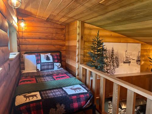 a small room with a bed in a cabin at Alyeska Spruce Cabin in Girdwood