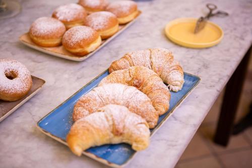 a bunch of pastries on trays on a table at Quartuccio - Albergo Diffuso - Gaeta in Gaeta